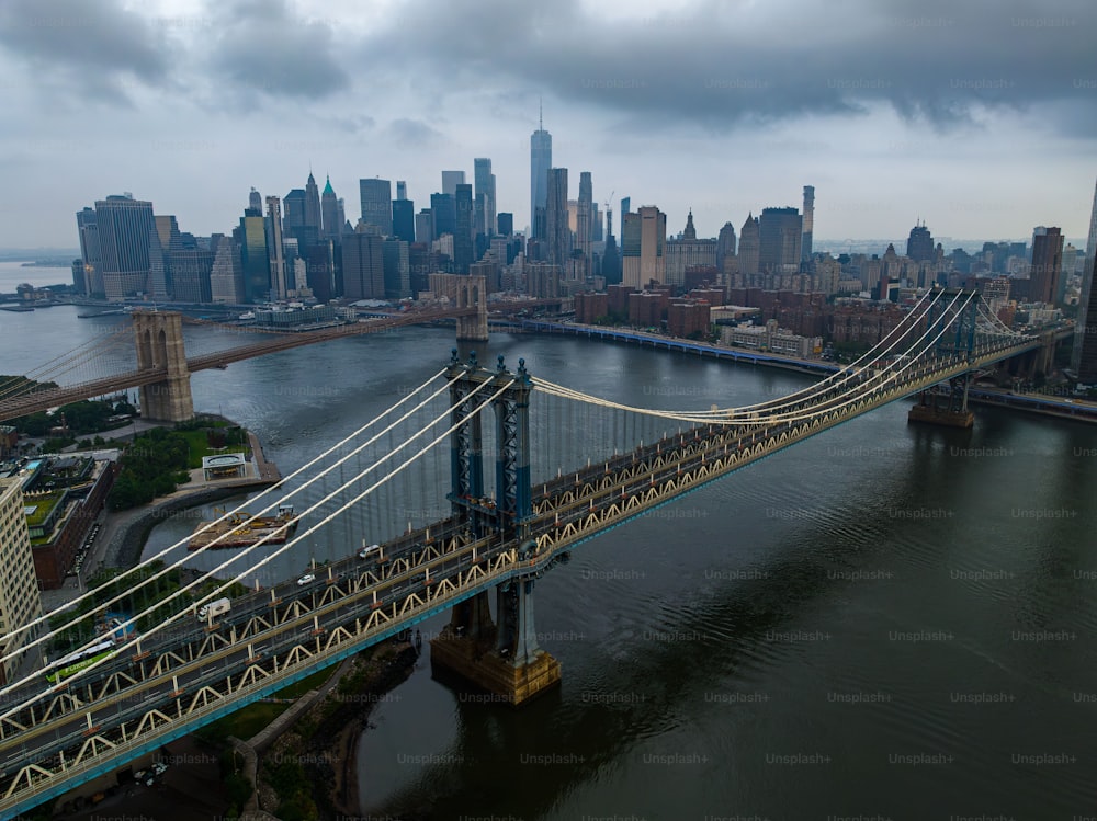 An aerial view of both the Manhattan and Brooklyn Bridges on a cloudy morning, seen from Brooklyn.