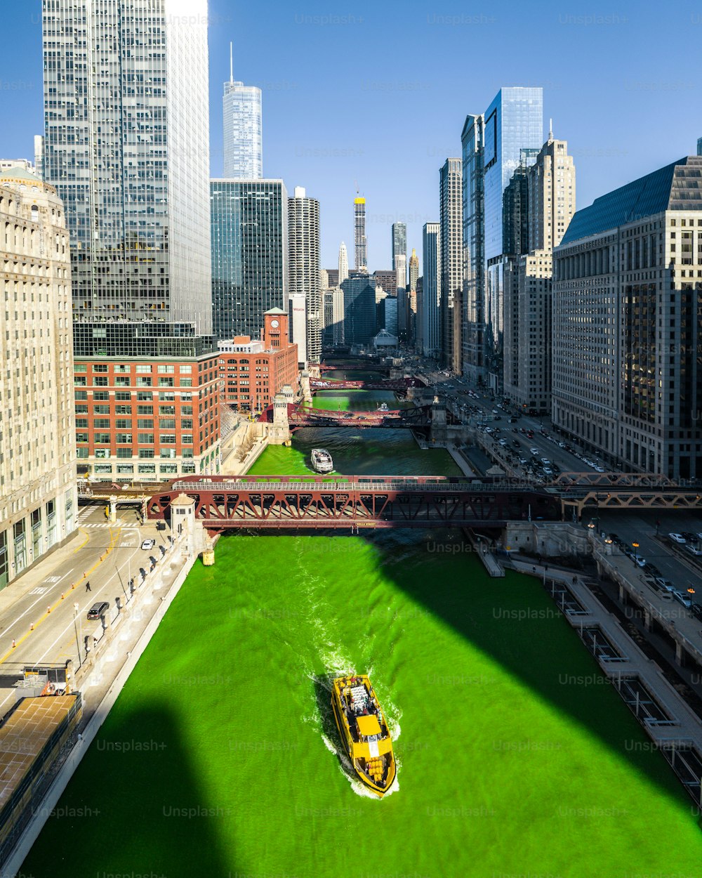 Die schöne Luftaufnahme des grünen Chicago River mit einem gelben Boot