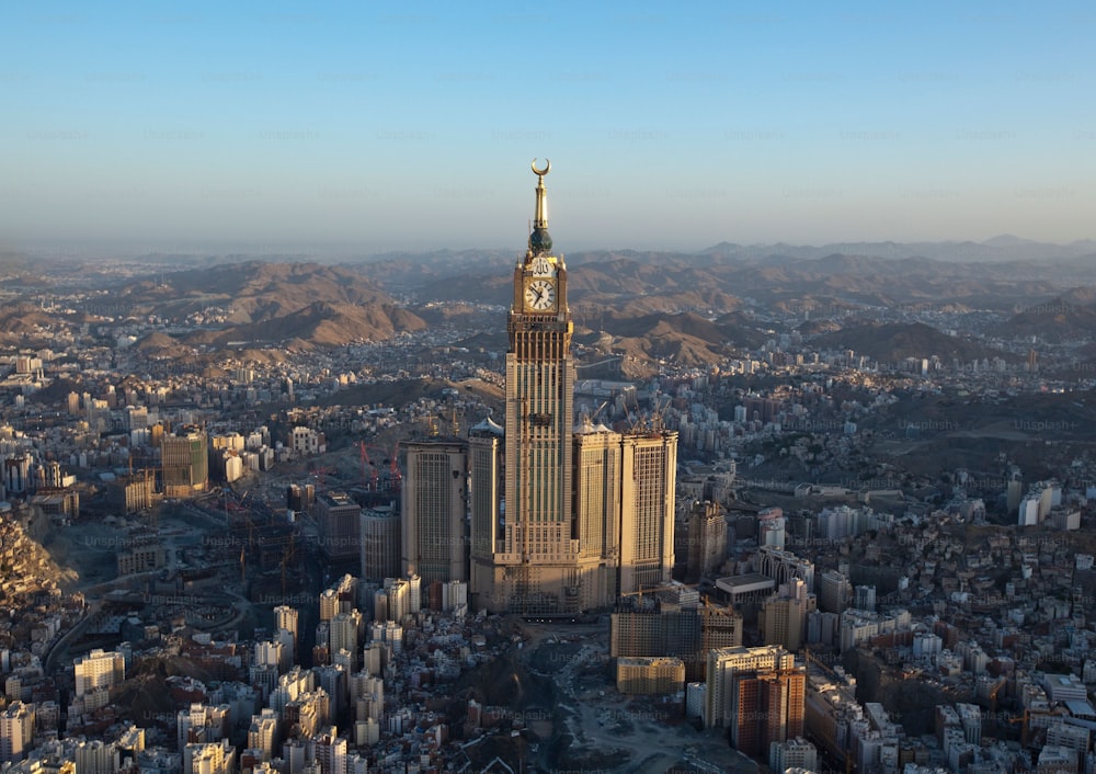 An aerial view of the vibrant urban cityscape of Saudi Arabia, featuring a towering spire.