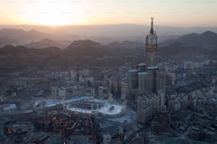 An aerial view of the vibrant urban cityscape of Saudi Arabia, featuring a towering spire.