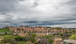 Cityscape of the famous medieval city of Avila in Spain surrounded by its ancient city Walls on a rainy day.