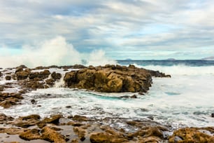 sunset with dramatic sky at the rocky coast in Tenesar, lanzarote