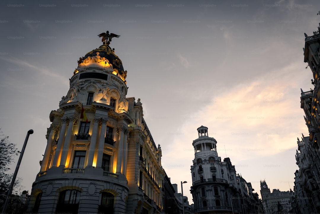 Night view of Madrid's Alcala and Gran Via streets. Several landmarks like the Metropolis Building or the Telefonica Bui