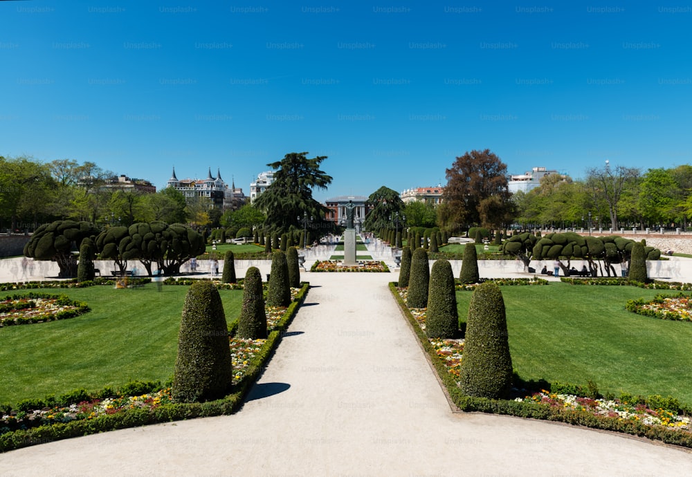 Tourists and locals walk around one of the main entrances to the Retiro Park (Parque del Buen Retiro) in Madrid, Spain.