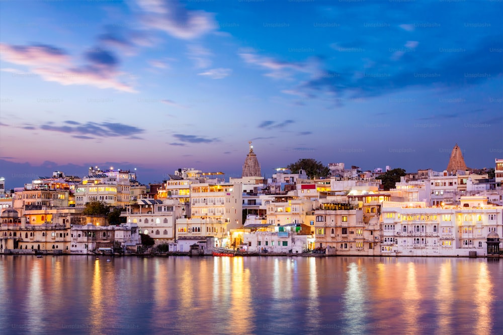 Evening view of  illuminated houses on lake Pichola in twilight, Udaipur, Rajasthan, India