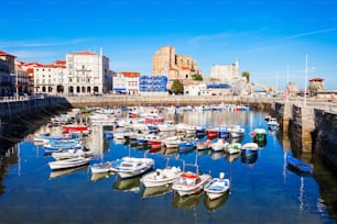 Boats at the port of Castro Urdiales, Santa Maria Church and Santa Ana Castle Lighthouse in Cantabria region in northern Spain.