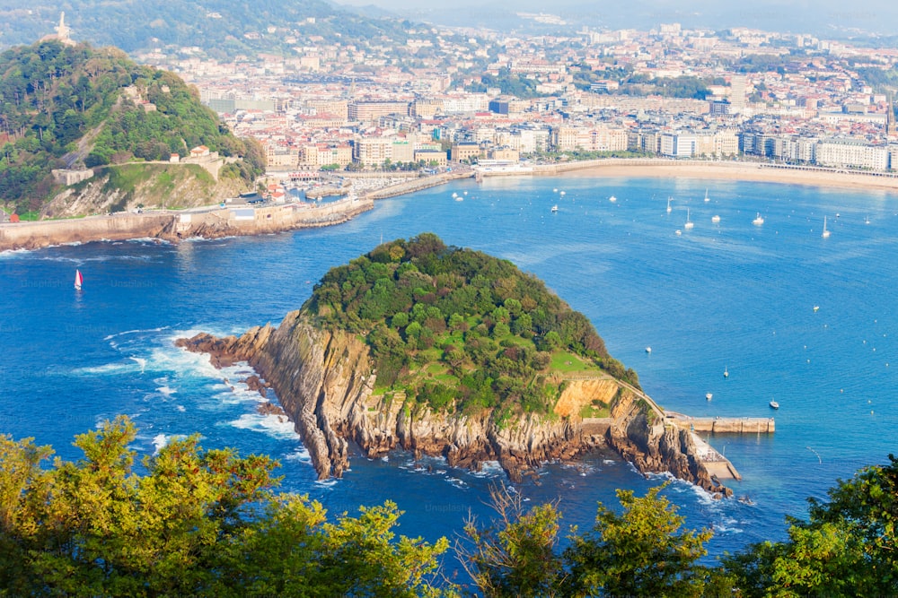 Santa Clara Island and San Sebastian Donostia city aerial panoramic view, Basque country in Spain