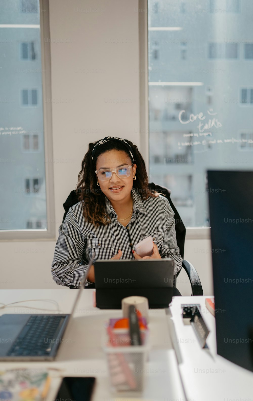 une femme assise à un bureau avec un ordinateur portable