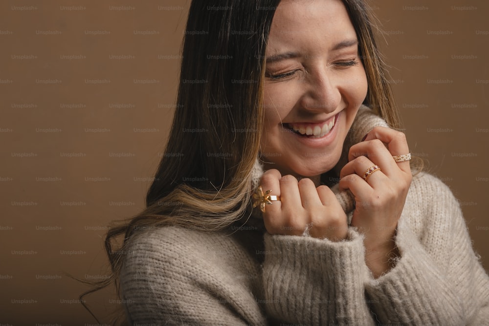 a woman smiling and holding onto a ring