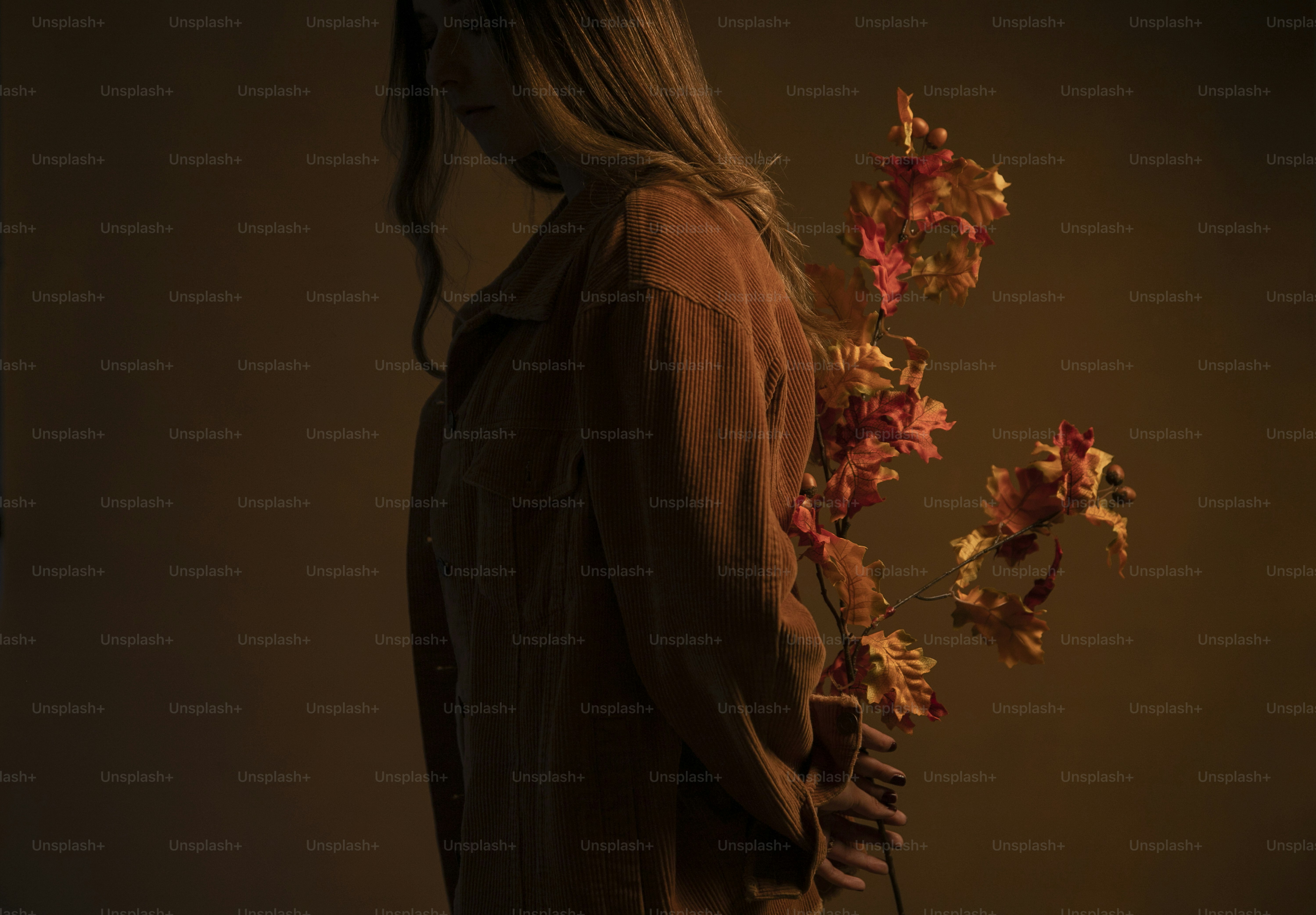 a woman holding a bunch of flowers in her hands