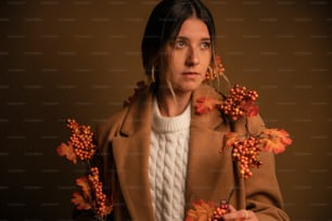 a woman holding a bunch of flowers in her hands