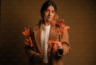 a woman is holding flowers in her hands