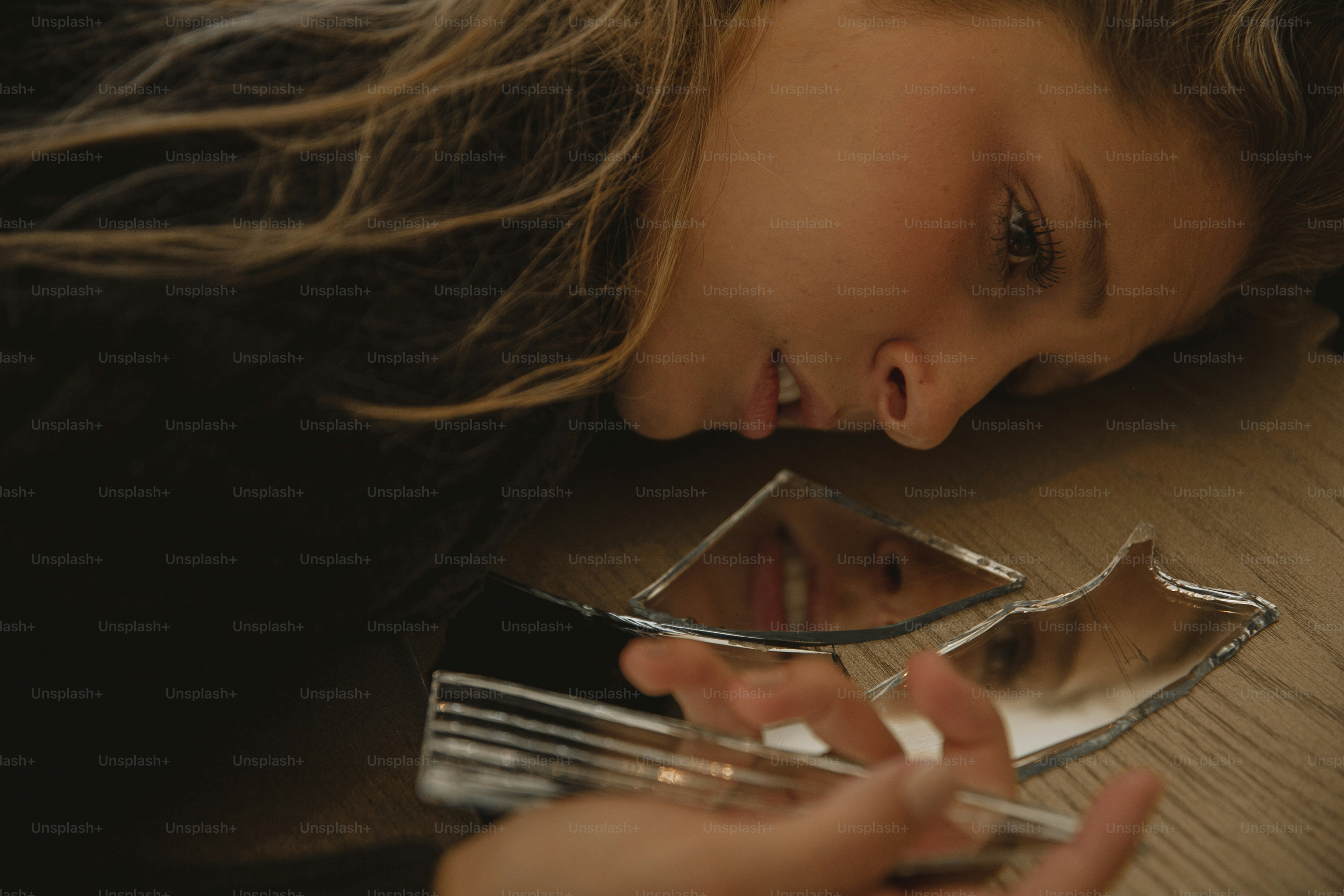 a woman laying on a table holding a cell phone