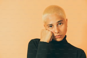 a woman with blonde hair and a black turtle neck sweater