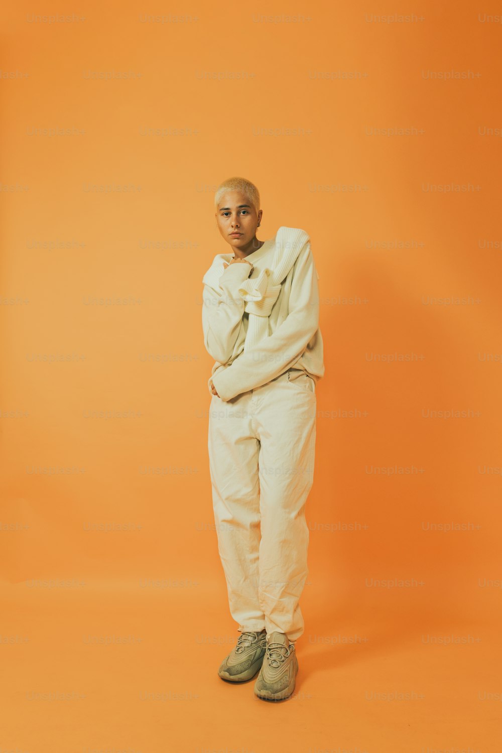 a man standing in front of an orange background