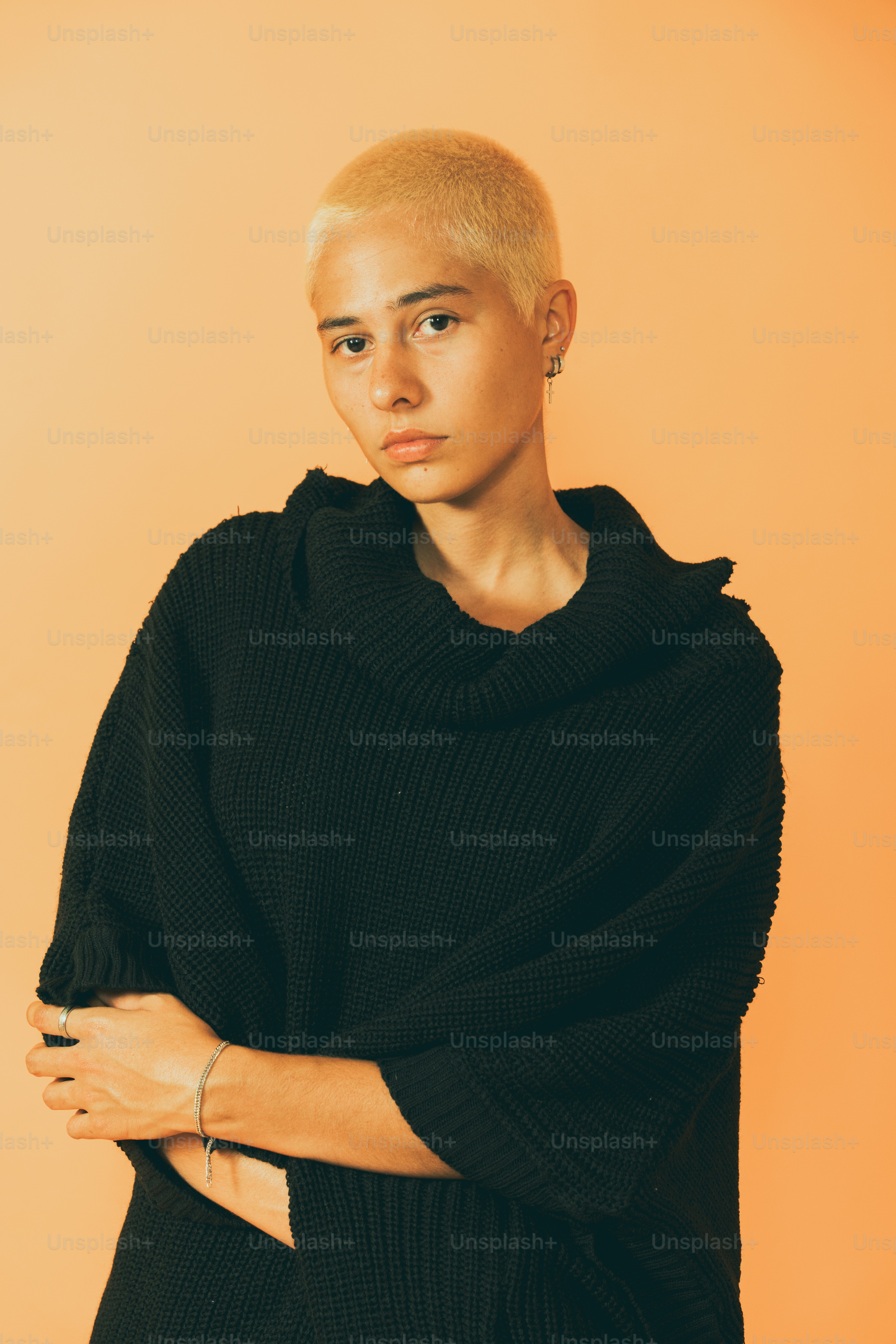 a woman with blonde hair wearing a black sweater