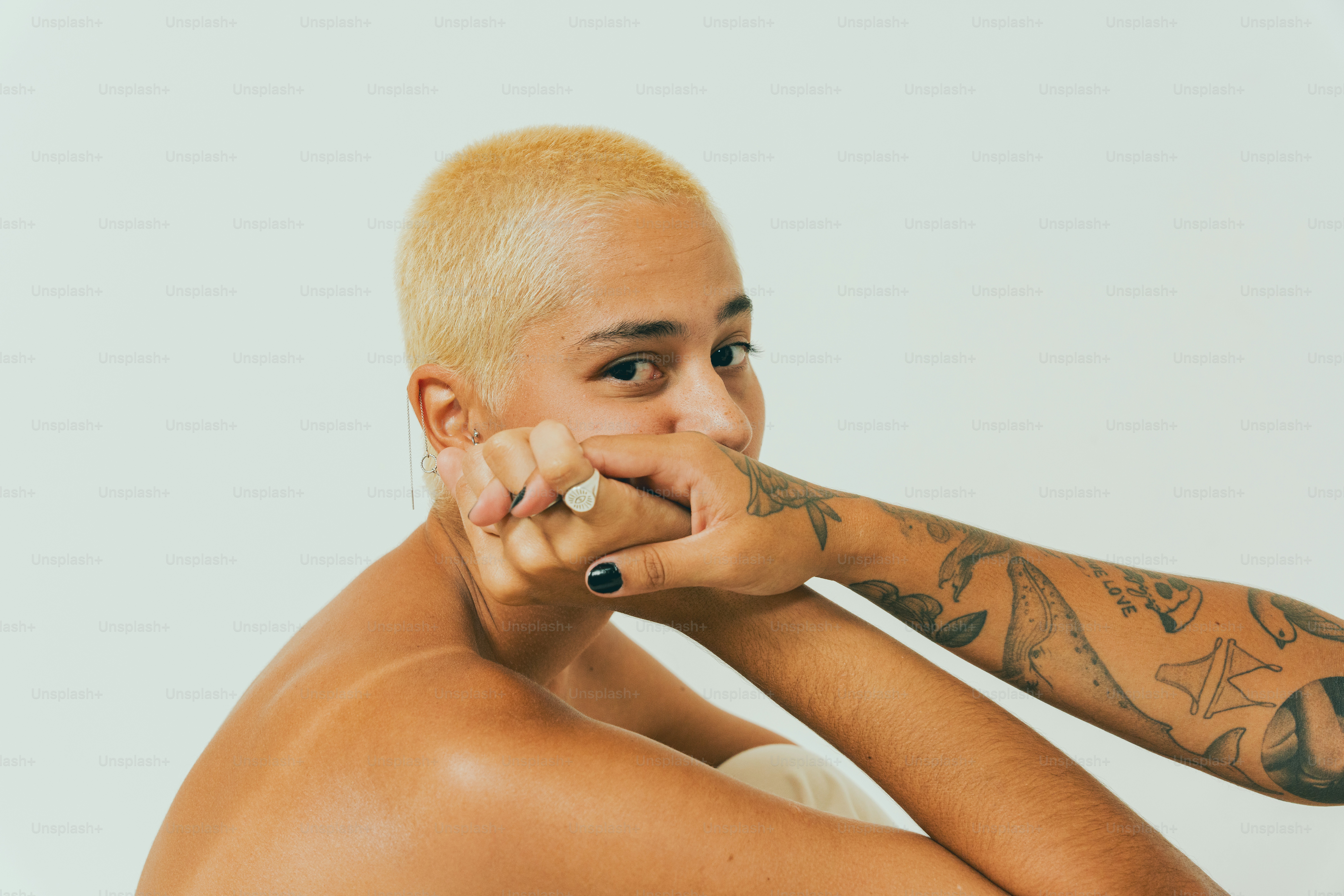 a shirtless man with tattoos on his arms