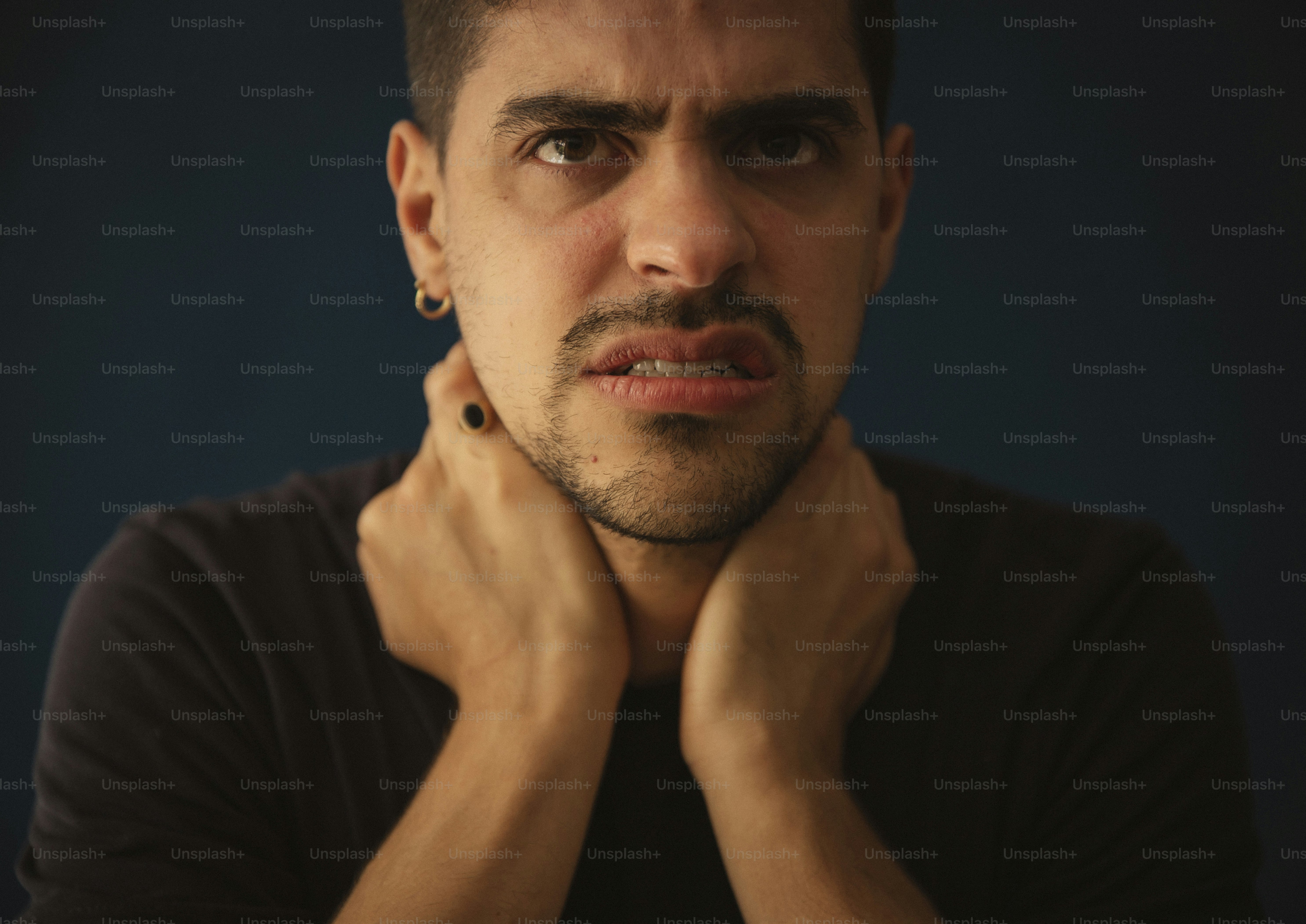 a man is posing for a picture with his hands on his chest