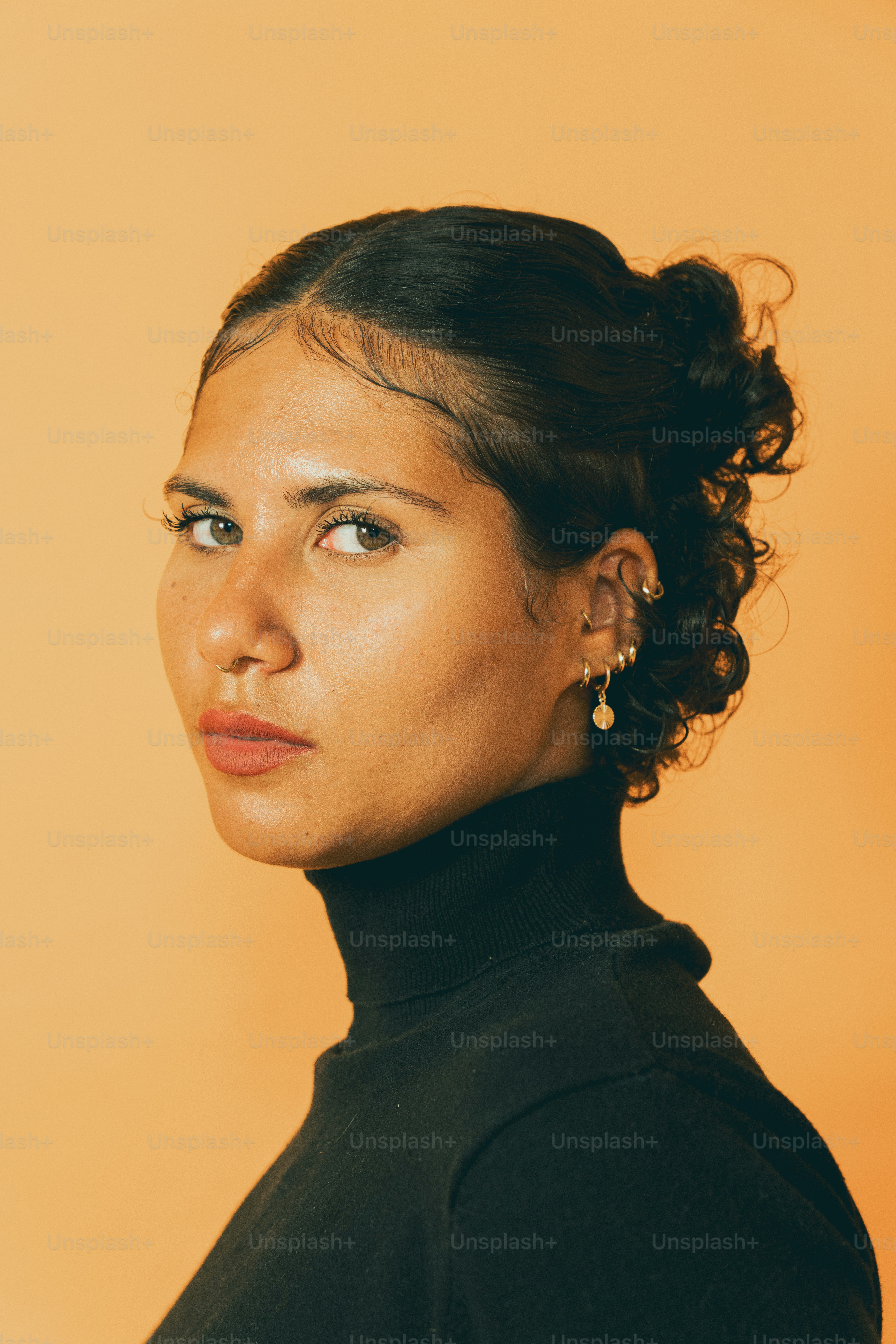 a woman wearing a black turtle neck sweater