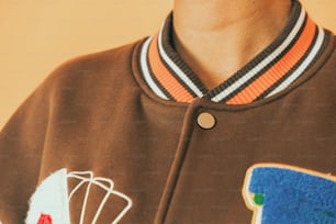 a close up of a person wearing a brown jacket
