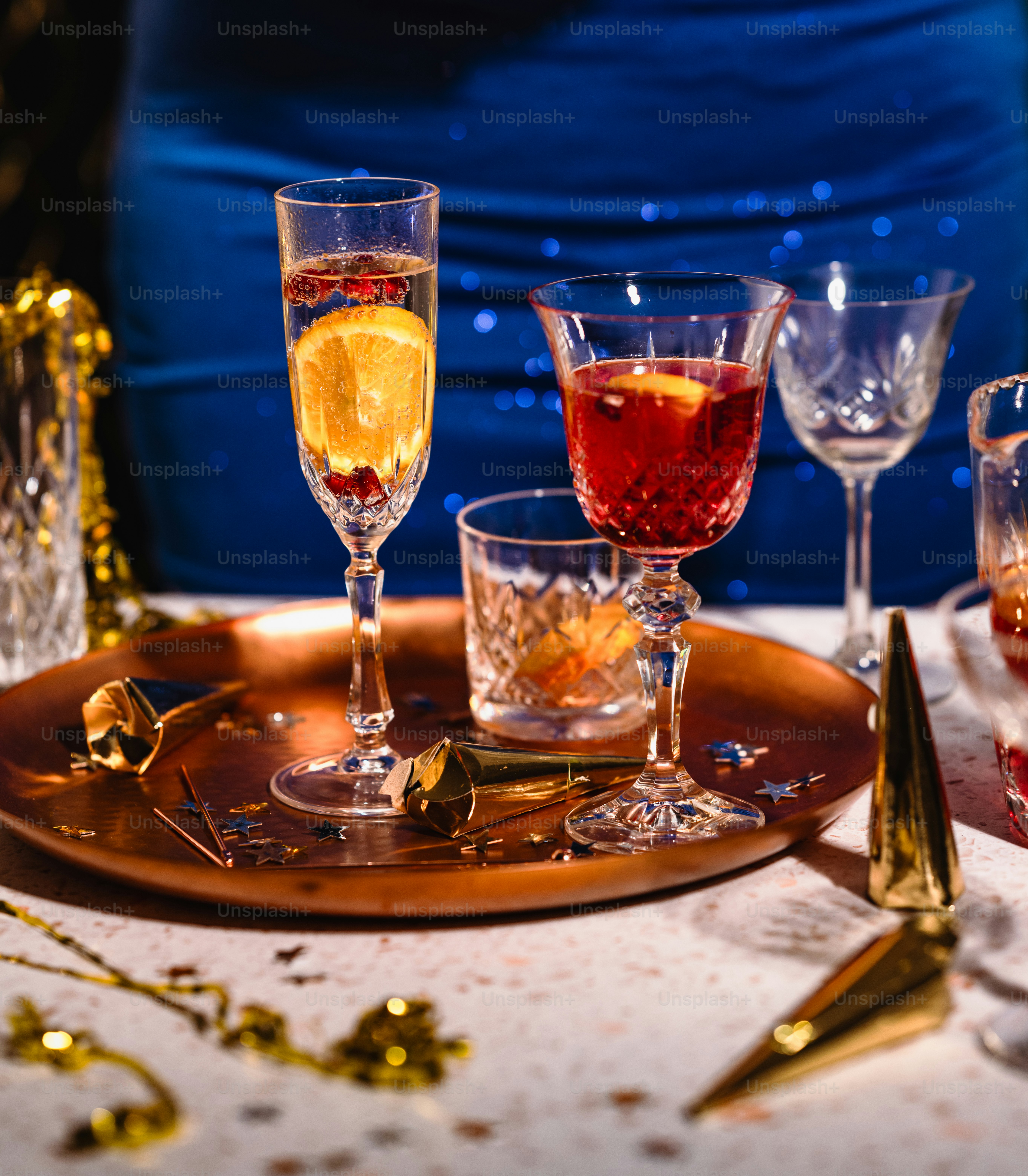 a table topped with glasses filled with different types of drinks
