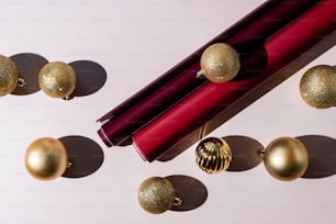 a close up of a lipstick and some christmas ornaments