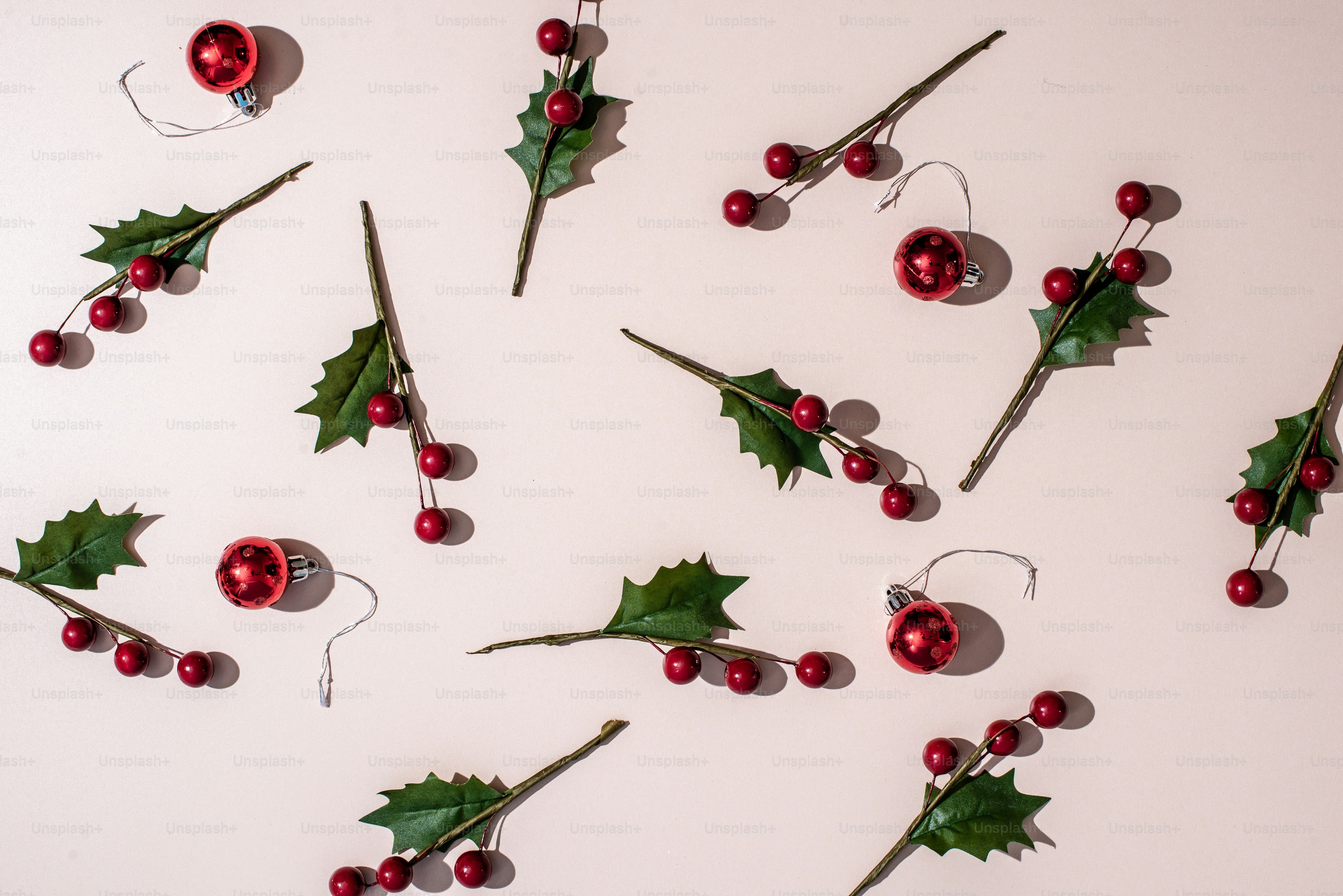 a collection of holly berry decorations on a white background