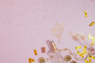 a bottle of champagne surrounded by confetti and streamers