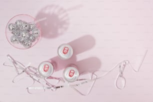 a pair of glasses sitting next to a bowl of silver beads