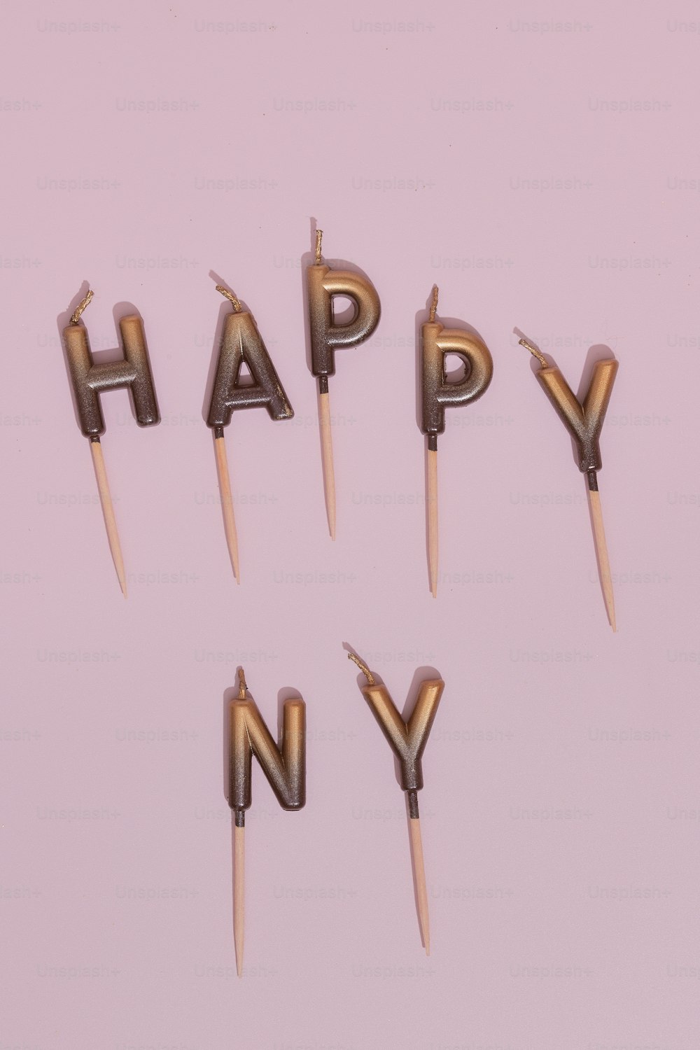 a group of candles that spell out the word happy n y