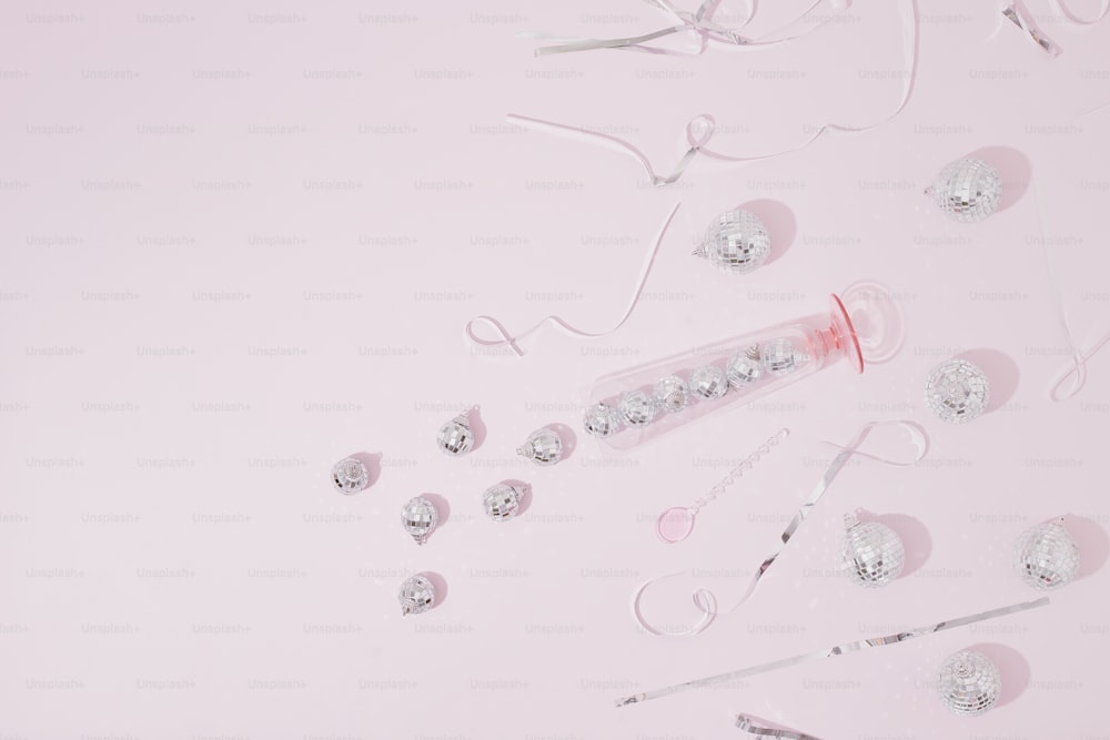 a pink table topped with a bottle of liquid and a pair of scissors