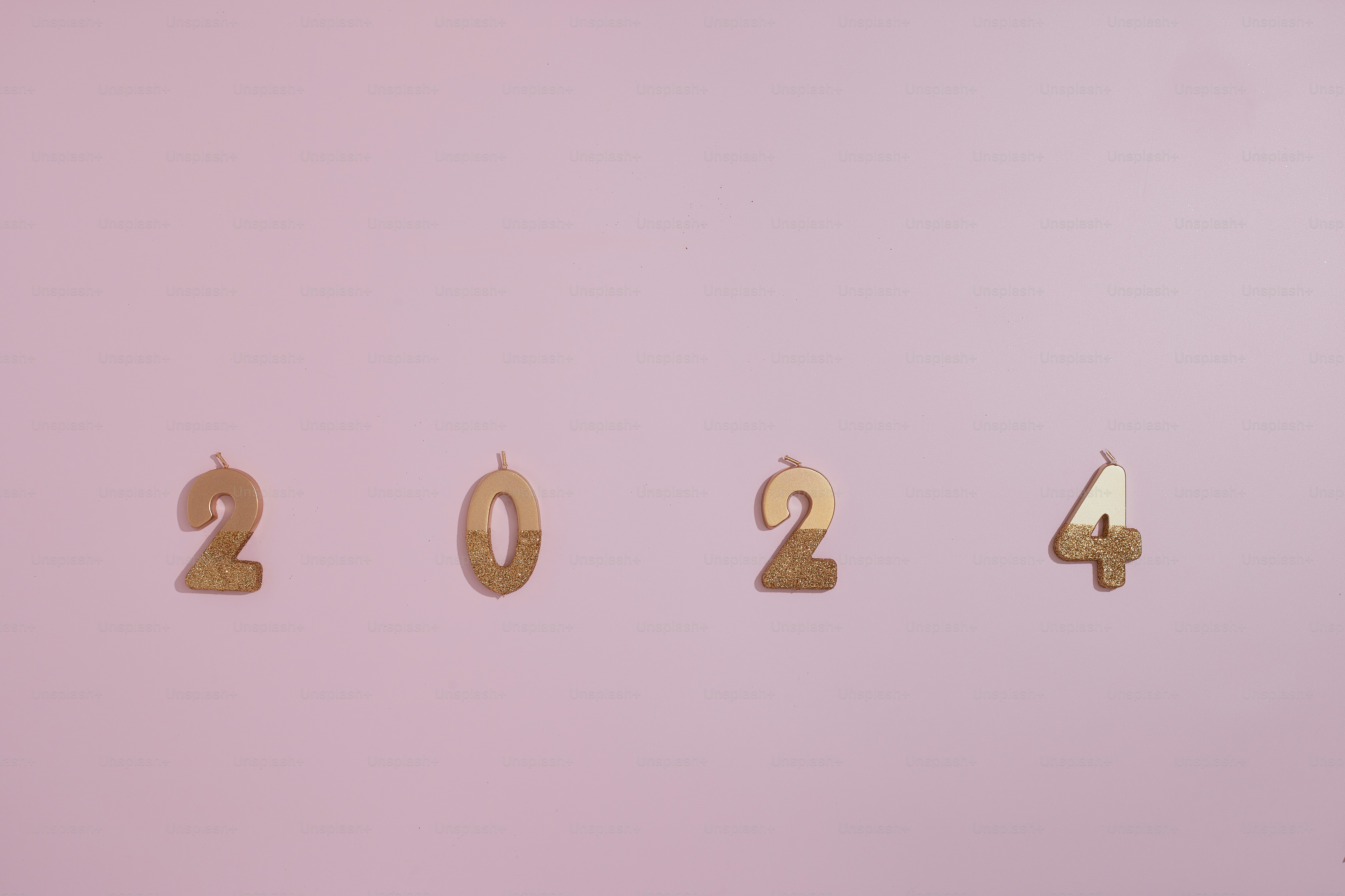 2024 candles on pink surface