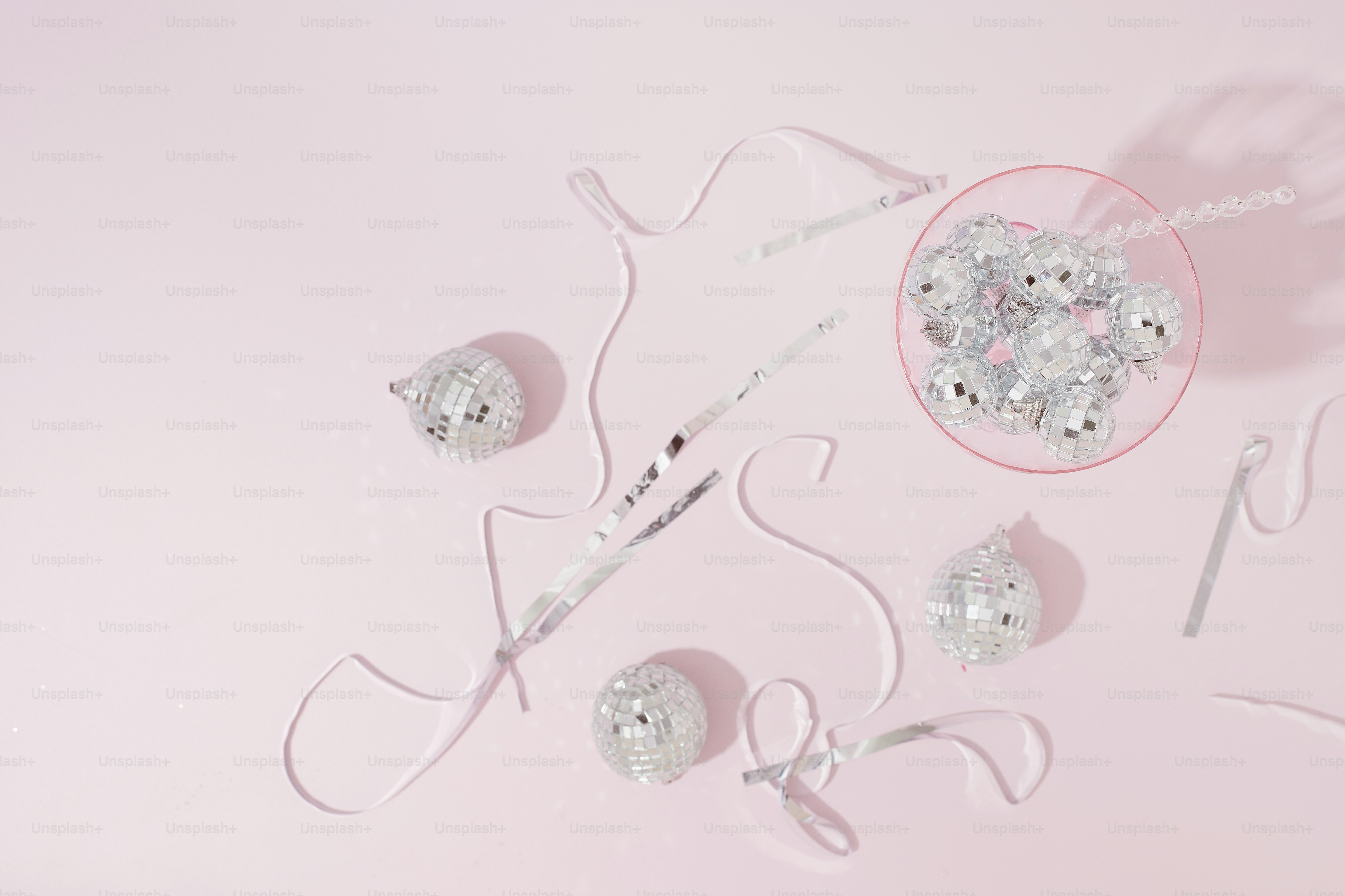 a pink table topped with lots of silver items