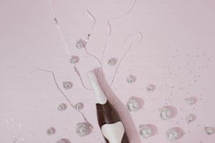 a black and white bottle of wine on a pink background
