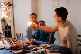 a man lighting a candle on a birthday cake
