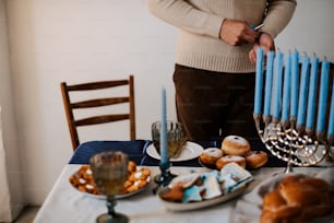 a man standing in front of a table filled with donuts