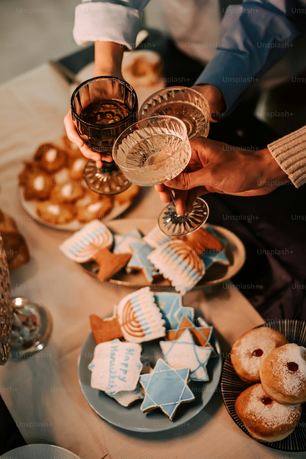 a table topped with plates of cookies and pastries