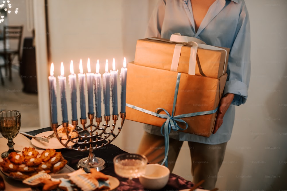 a man holding a box of gifts in front of a hanukkah men