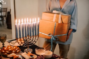 a man holding a box of gifts in front of a hanukkah men