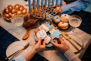 a table with a hanukkah menorah and cookies on it
