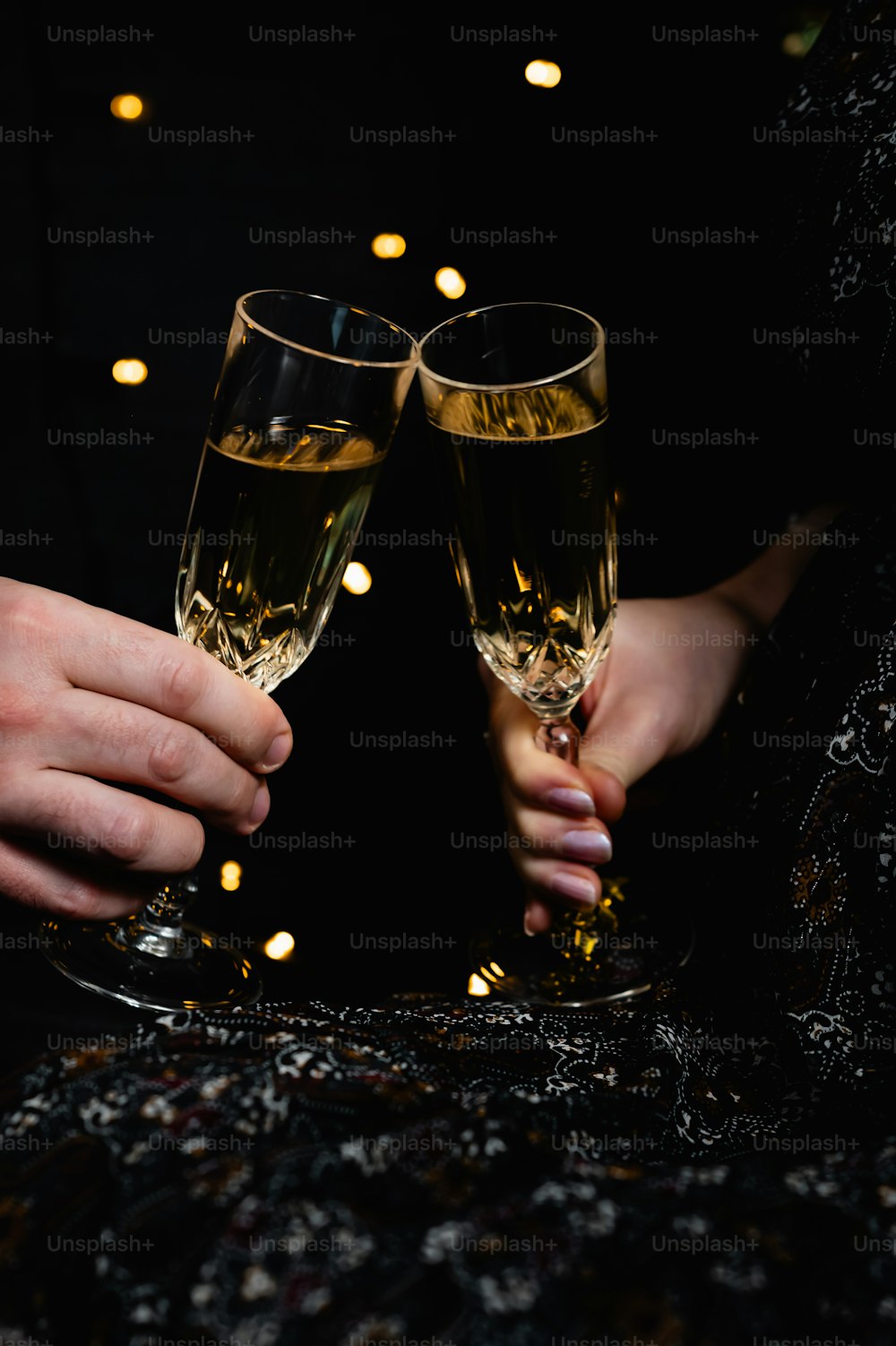 duas pessoas segurando taças de champanhe nas mãos