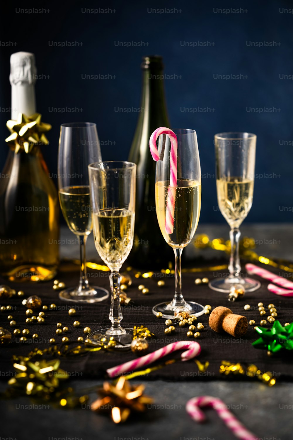 a table topped with glasses of champagne and candy canes