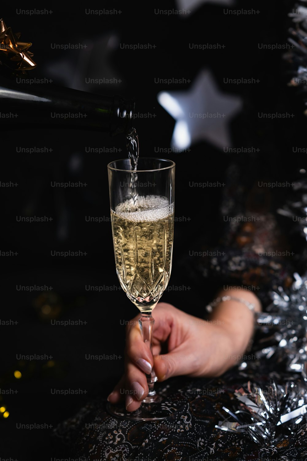 a person is holding a glass of champagne