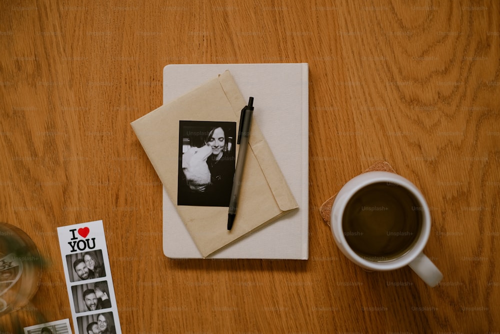 a notepad with a picture of a couple on it next to a cup of