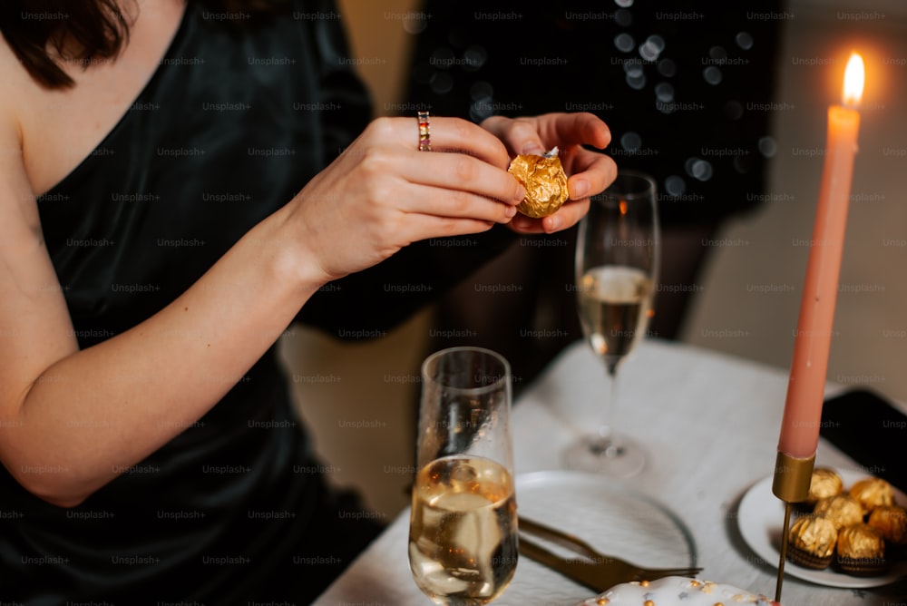 a woman in a black dress holding a piece of food