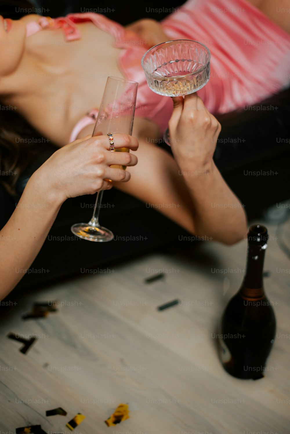 a woman laying on a couch holding a wine glass