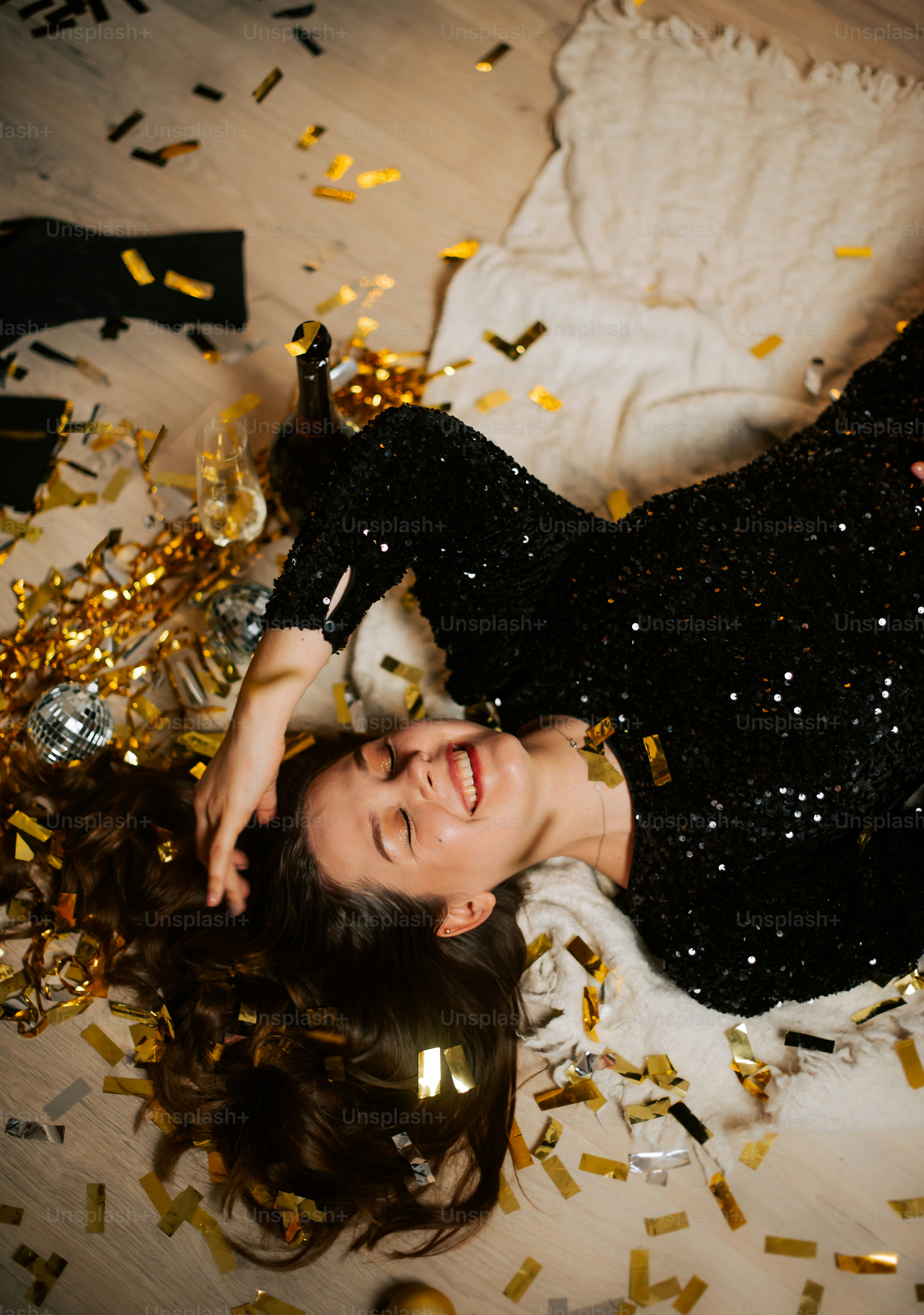 a woman laying on the floor surrounded by confetti
