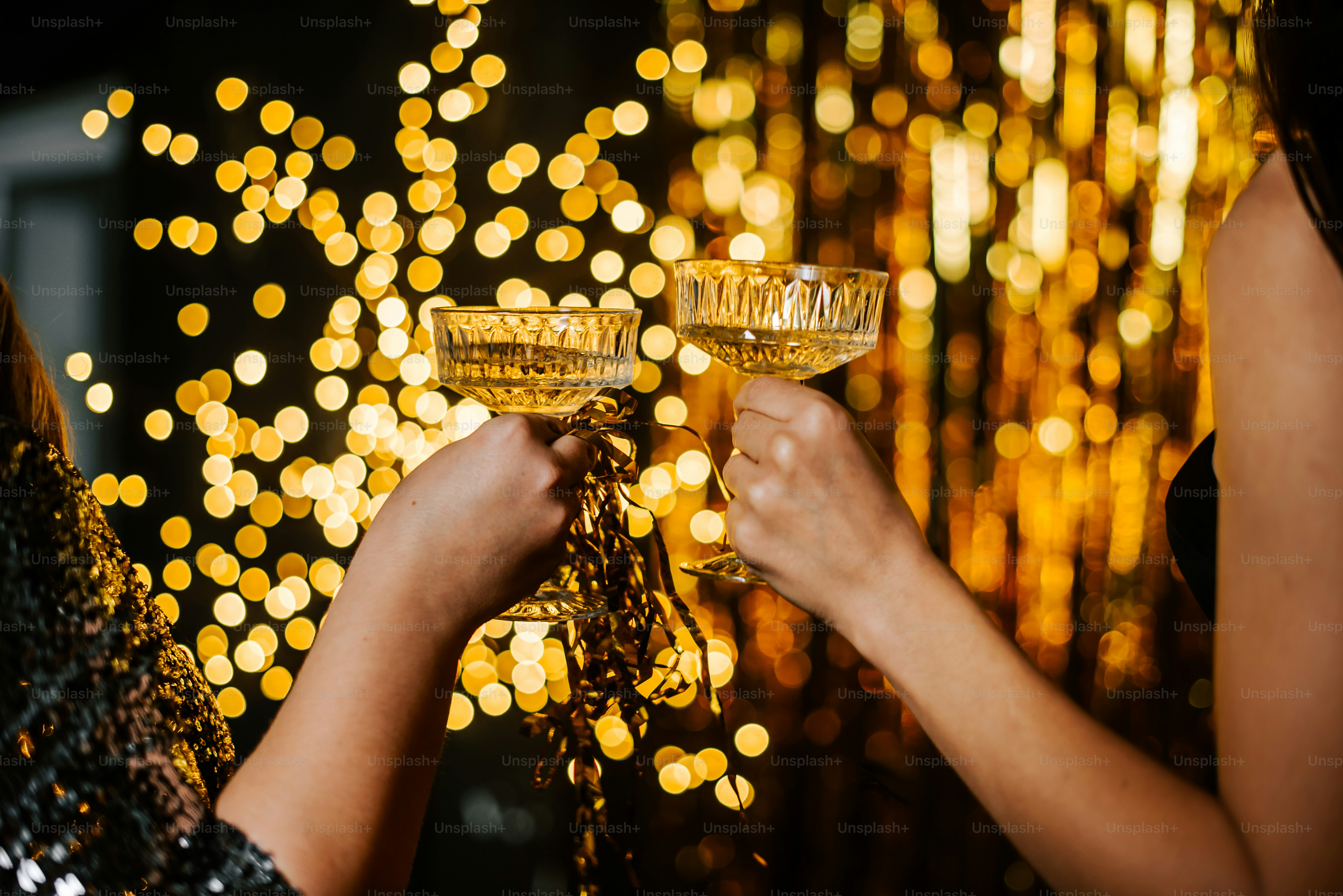 a couple of women holding glasses of champagne