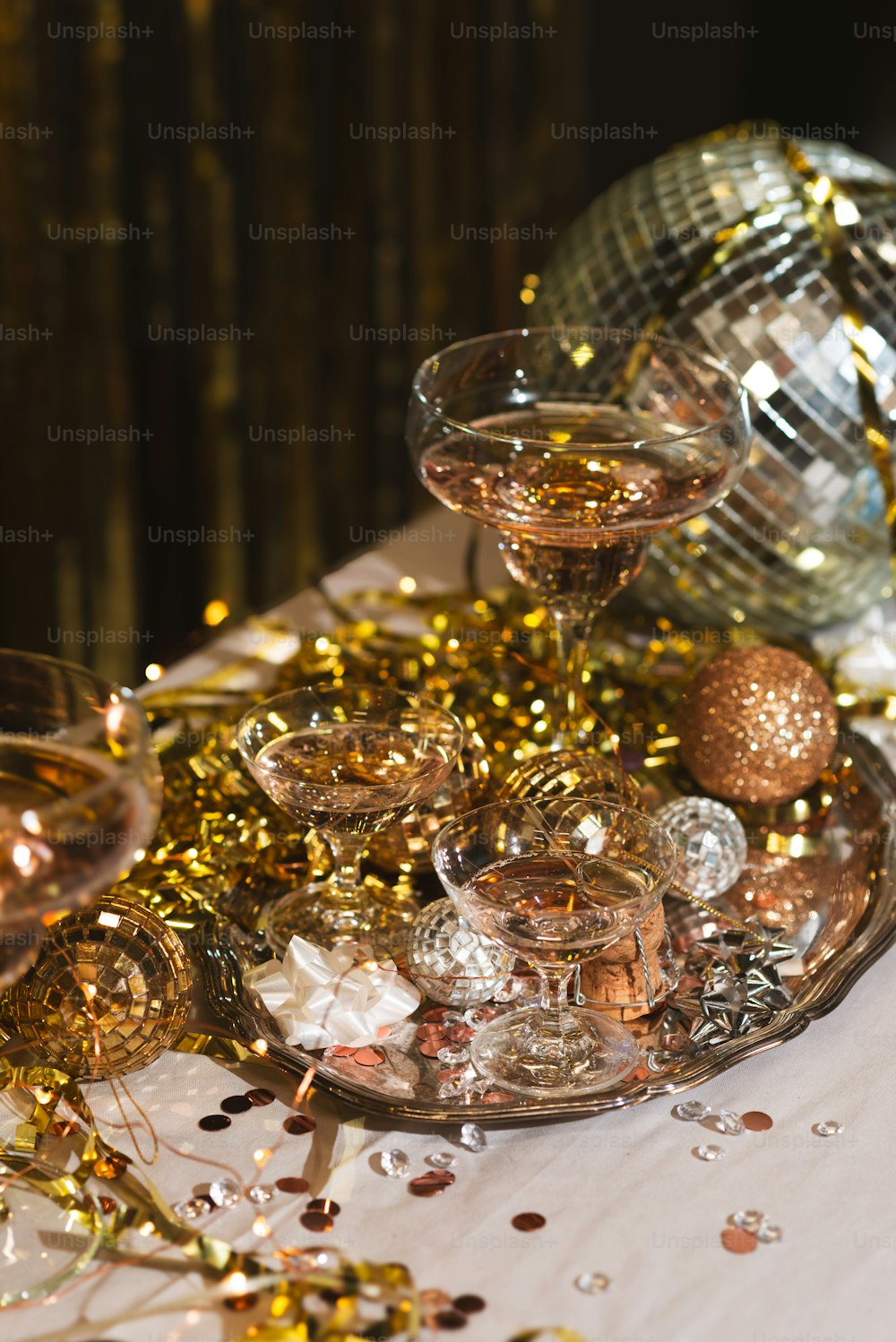 una mesa cubierta con copas de vino y confeti