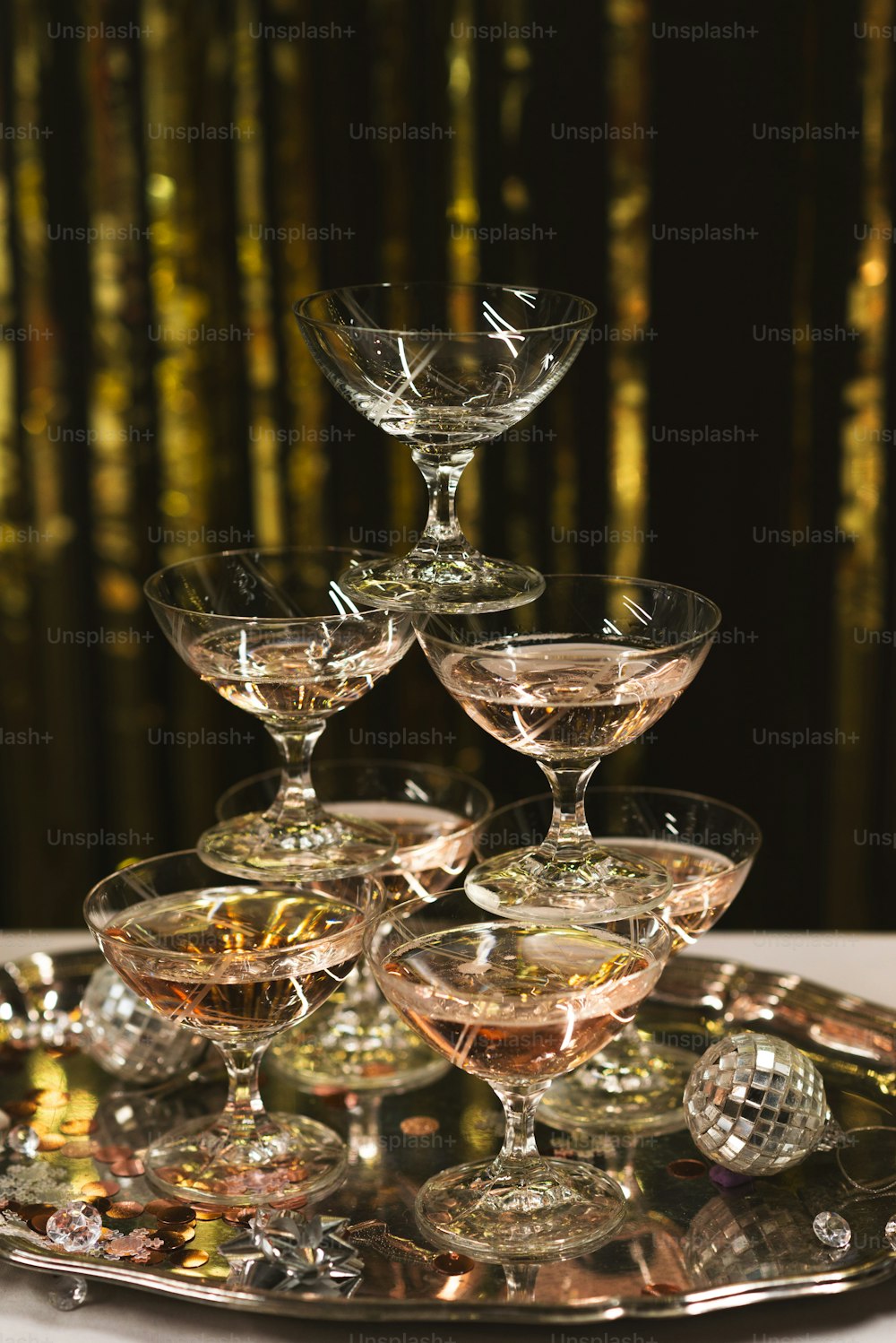 a silver tray topped with wine glasses on top of a table